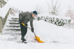 History of Snow Blowers, Man shoveling snow