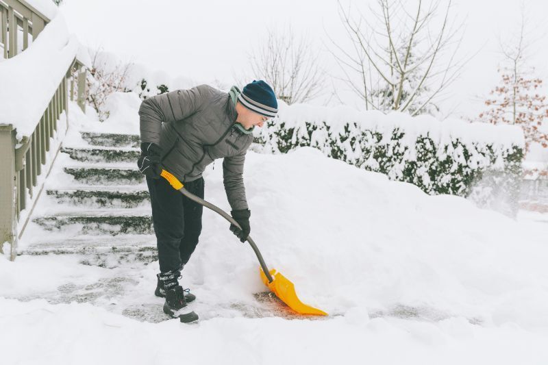 History of Snow Blowers, Man shoveling snow