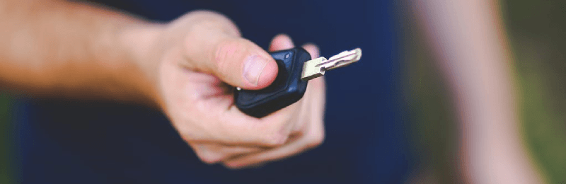 Man Holding Car Key Fob