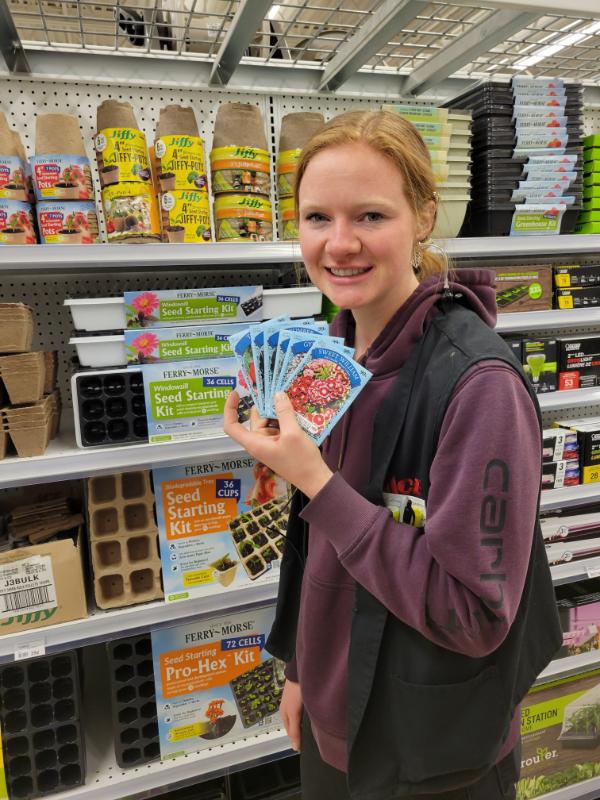 Ace Employee Holding Up Plant Seed Packets