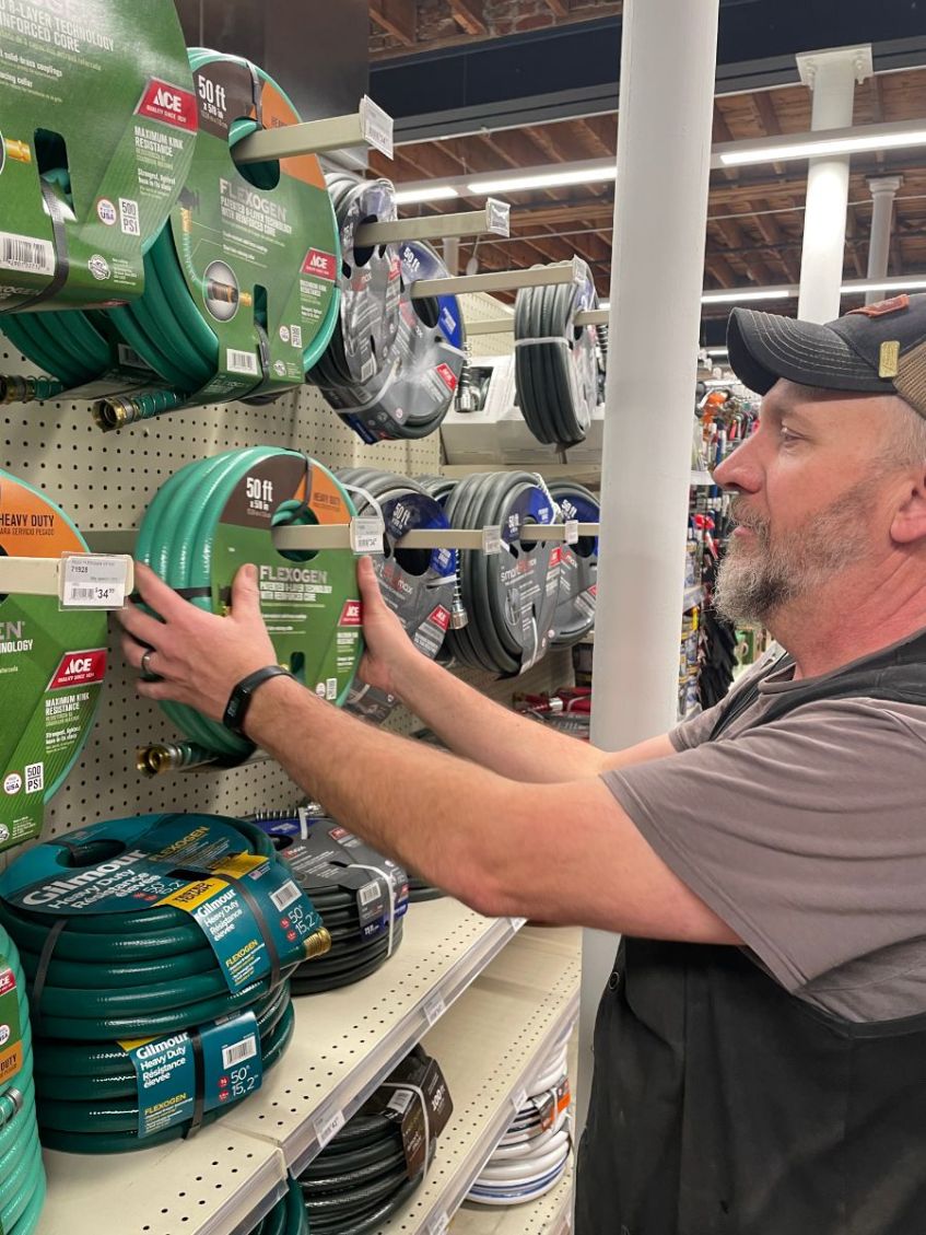 Employee Stocking Hoses in Ace Lawn Department