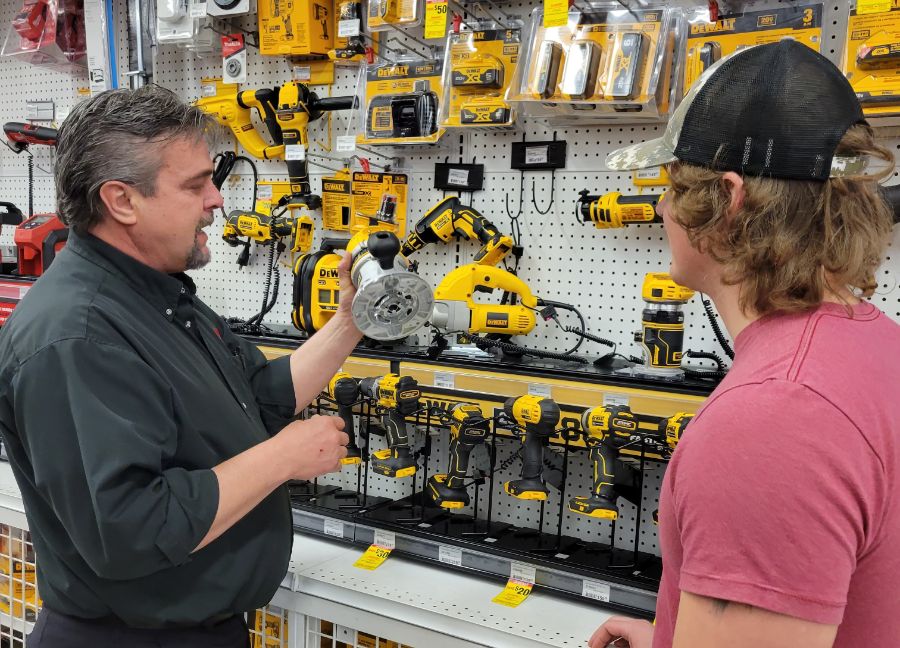 owenhouse ace hardware team member tony helping a customer in power tool isle