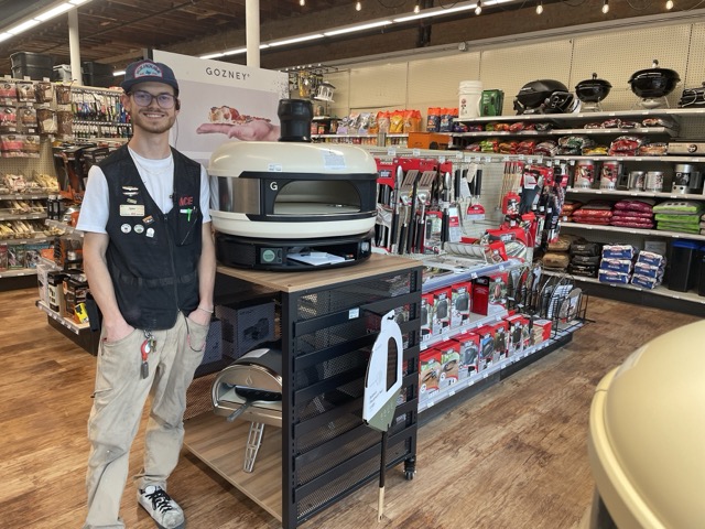 owenhouse team member tyler in front of gozney pizza oven