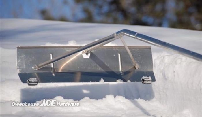 Using a roof rake in Bozeman to remove heavy snow and prevent ice dams during Montana winters