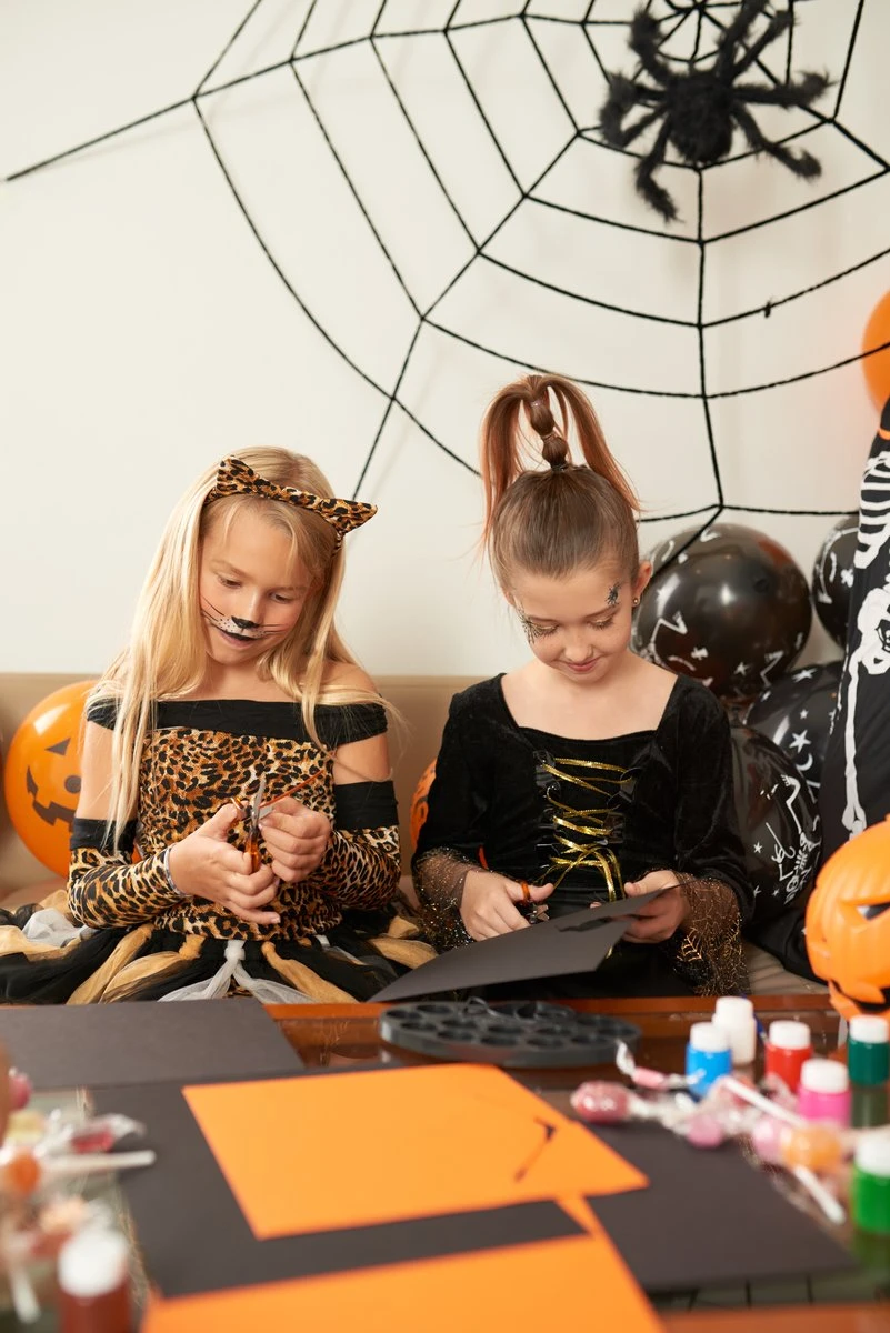 DIY Halloween Crafts for kids with orange paper and homemade spiders