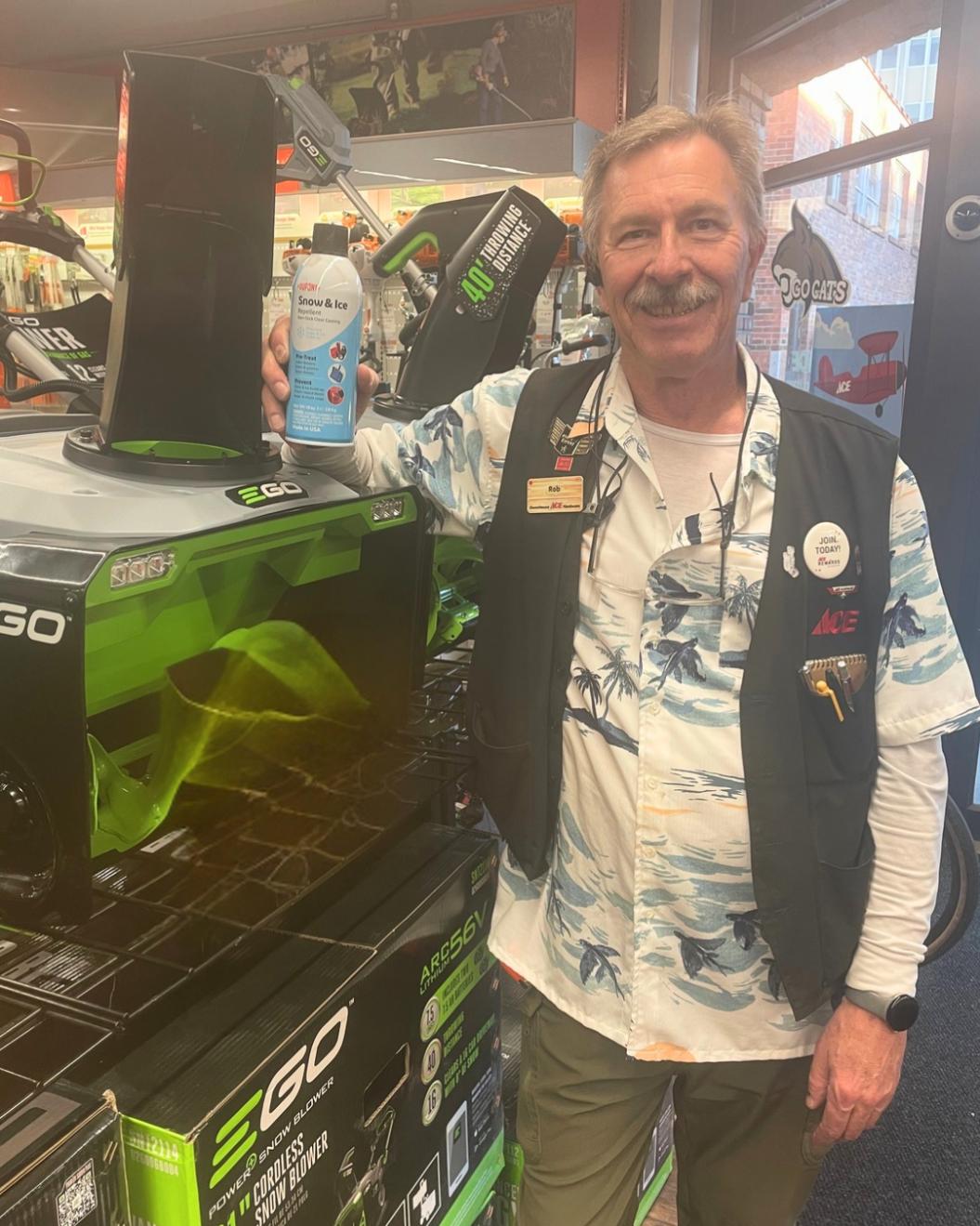 Rob from Owenhouse Ace Downtown standing beside EGO power equipment in the store.