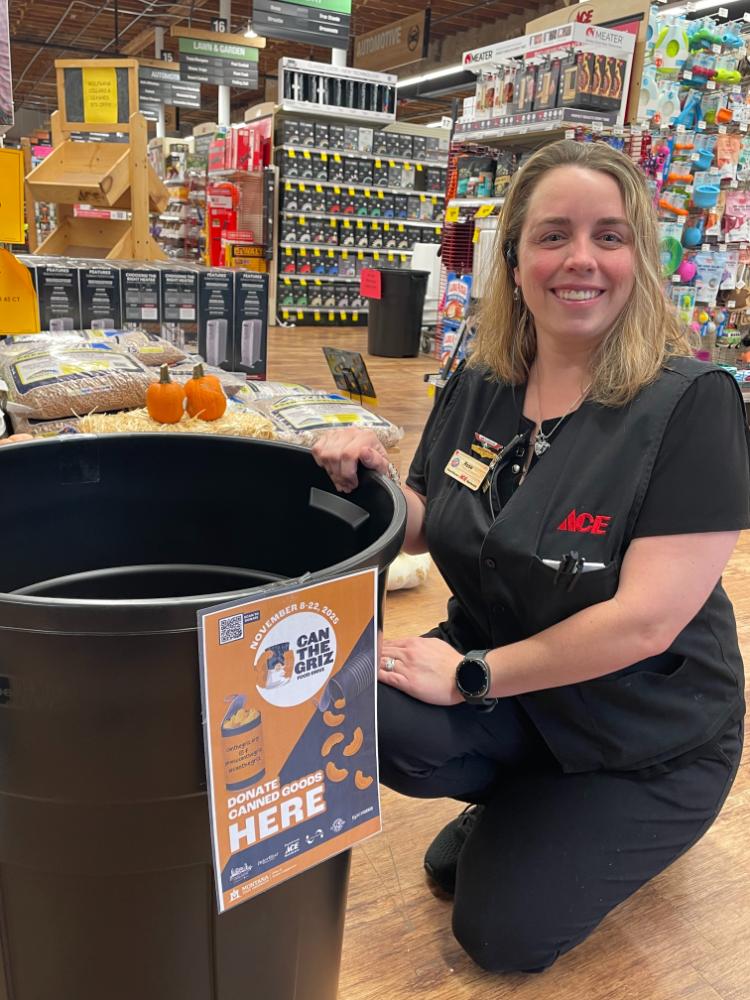 owenhouse ace hardware team member sitting in front of the can the griz food drive can