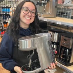 owenhouse team member holding up the bambino espresso maker by breville