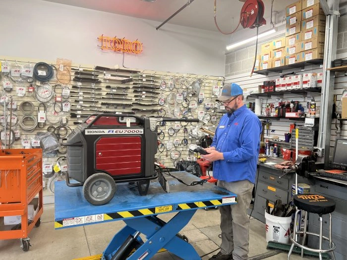 man working on honda generator preparing for winter in bozeman montana
