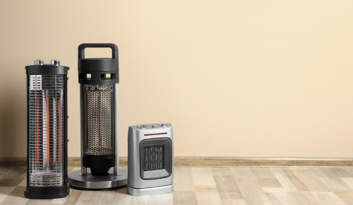 three space heaters in an empty room