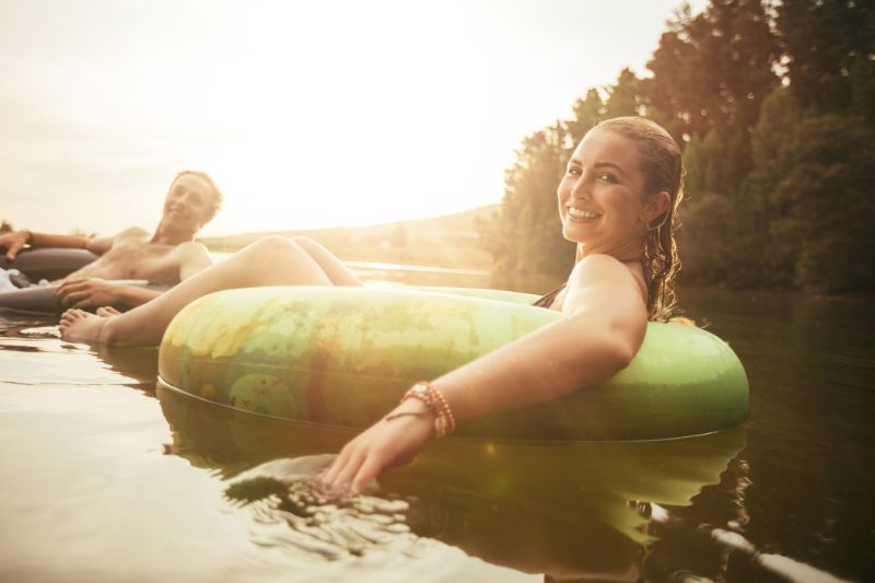 A couple floats happily down a river on tubes